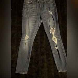 Ladies True Craft skinny jeans with tears. Size can be considered juniors.